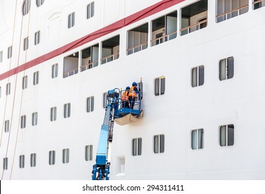 Workers Cleaning Windows On Cruise Ship In Port