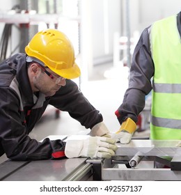 Workers In CNC Machine Shop With Lathes Close Up