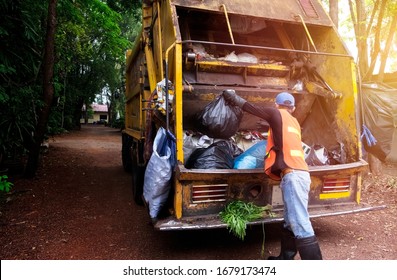 Workers Collect Garbage With Garbage Collection Truck