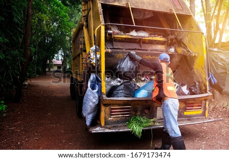 Workers collect garbage with Garbage collection truck