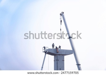 Workers constructing a bridge interchange ,Supporting elevated bridges Construction worker and crane, construction equipment at construction site.