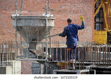 Workers At Construction Site Casting A Concrete Mixture Into The Form, Creating Demountable And Permanent Formwork