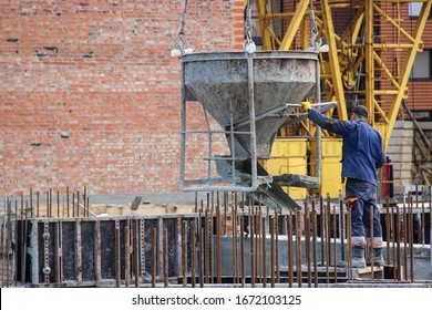 Workers At Construction Site Casting A Concrete Mixture Into The Form, Creating Demountable And Permanent Formwork