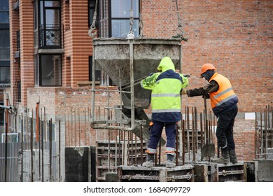 Workers At Construction Site Casting A Concrete Mixture Into The Form, Creating Demountable And Permanent Formwork