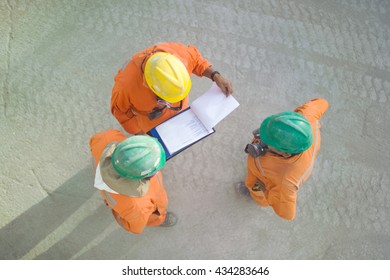 Workers Of A Copper Mine Reviewing A Sheet