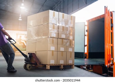 Workers Courier Unloading Packaging Boxes pallets into Shipping Container. Delivery Man. Truck Loading at Dock Warehouse. Supply Chain. Shipments. Shipping Warehouse Logistics and Cargo Transport.	