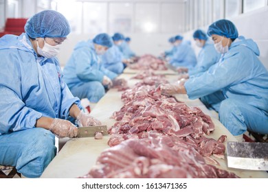 Workers Cut Pork At Slaughterhouse