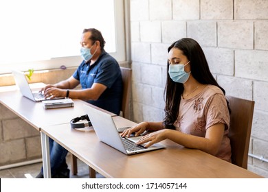 Workers Doing Office Work On Computers With Social Distance And Face Masks In Times Of The COVID-19 Pandemic.