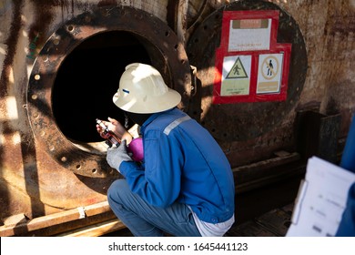 Workers Enter The Confined Space At The Oil Storage Tank For Maintenance Work.