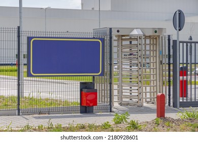 Workers Entrance Turnstile Doors At Factory Gate Fence