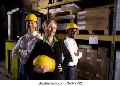 Workers With Female Boss In Storage Warehouse