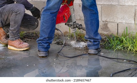 Workers Fixing A Water Leak And Using A Jack Hammer To Break The Cement