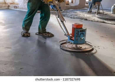 The Workers Grind The Concrete Floor At The Construction Site