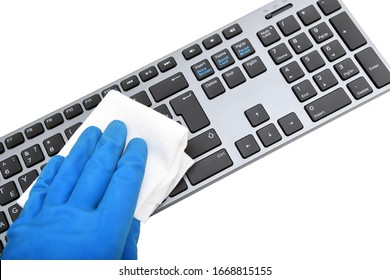 Worker's Hand Wipes Dust And Dirt On The Keyboard. A Maid Or Housewife Takes Care Of The House. General, Regular Cleaning. The Concept Of A Commercial Cleaning Company
