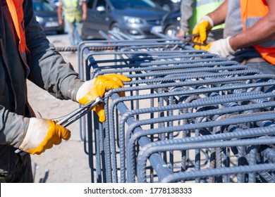 Workers Hands Using Iron Wire For Securing Iron Bars With Wire Rod For Reinforcement Iron Reinforcement In The Construction Site