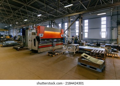 Workers and industrial machinery at metalworking factory production line. - Powered by Shutterstock