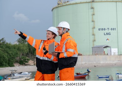 Workers inspect LNG facility while discussing safety procedures near the harbor