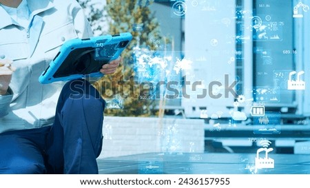 Workers inspecting equipment and digital data. Industrial technology. IIoT. Industrial Internet of Things.