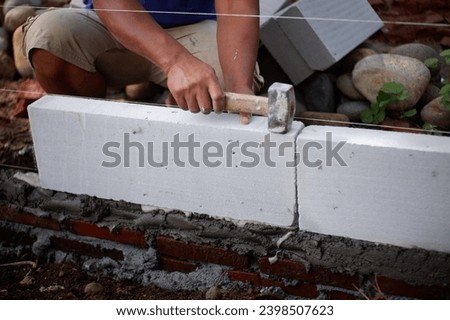 Workers Install Light Bricks, Indonesia, December 9, 2023, workers install light bricks, a type of brick made from a molded mixture of cement and sand Stock photo © 