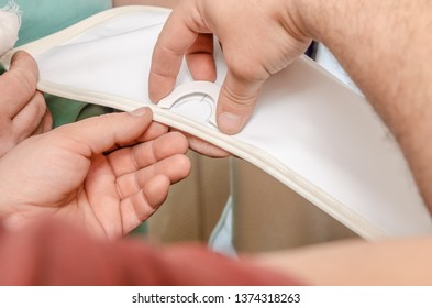 workers install a suspended ceiling, make a hole under the pipes close-up
