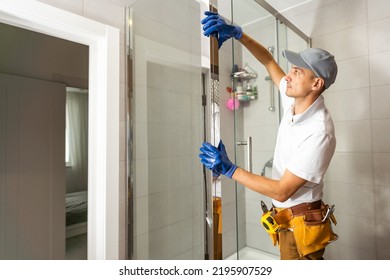 Workers Are Installing Glass Door Of The Shower Enclosure