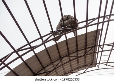 Workers are installing a metal canopy. Technologies