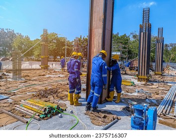 Workers installing panel columb formwork at the construction of a building