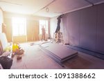 Workers are installing plasterboard (drywall) for gypsum walls in apartment is under construction, remodeling, renovation, extension, restoration and reconstruction.