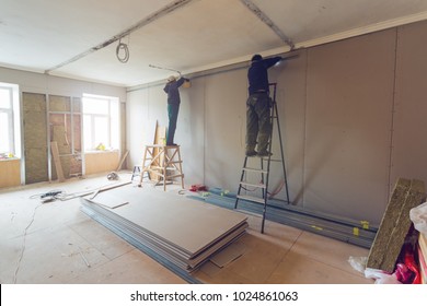 Workers are installing plasterboard (drywall) for gypsum walls in apartment is under construction, remodeling, renovation, extension, restoration and reconstruction. - Shutterstock ID 1024861063