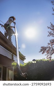 Workers installing solar panel on roof for renewable energy