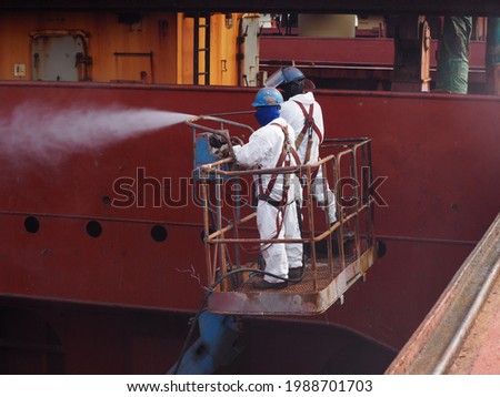 workers or labours is doing hydro blast on cargo hold bulkhead of a bulk carrier in dry dock.