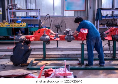 The workers in the machine shop are working.