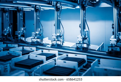 Workers And Machinery In A Solar Panel Manufacturing Industry Factory.