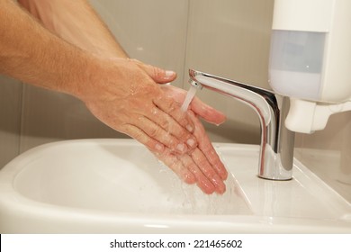 Workers Male Hands Under Running Water In The Sink With Automatic Crane