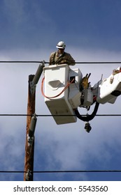 Workers In A Man Lift Aka Bucket Lift Prepare To Remove And Replace A 95 Foot Utility Pole Broken By A Car Accident