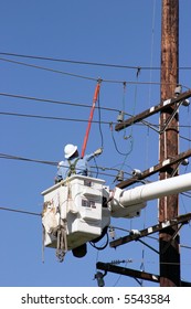 Workers In A Man Lift Aka Bucket Lift Prepare To Remove And Replace A 95 Foot Utility Pole Broken By A Car Accident