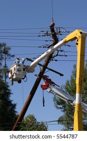 Workers In A Man Lift Aka Bucket Lift Prepare To Remove And Replace A 95 Foot Utility Pole Broken By A Car Accident