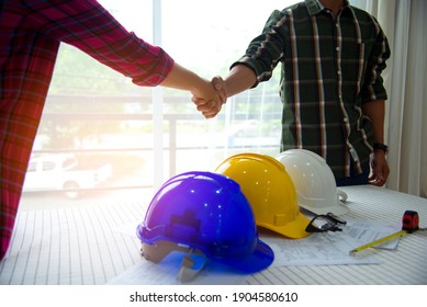 Workers And Manager In Safety Helmets Working With Documents At Factory .Engineer Concept