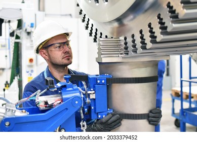 Workers Manufacturing Steam Turbines In An Industrial Factory 