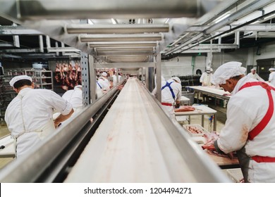 Workers At Meet Industry Handle Meat Organizing Packing Shipping Loading At Meat Factory.
