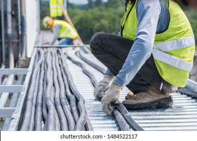 Workers are moving cables in construction sites. - Shutterstock ID 1484522117