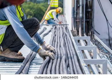 Workers are moving cables in construction sites. - Shutterstock ID 1486244435