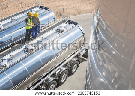 Similar – Foto Bild Zwei Tanklastzüge überqueren eine Autobahn über eine Brücke, Luftaufnahme.