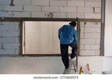 The workers are plastering and doing construction work.