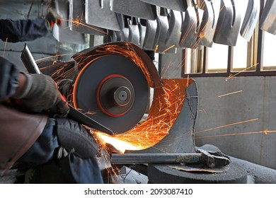 Workers Polish Steel Shovels With Grinding Wheels In A Shovel Factory In North China