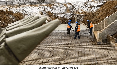 Workers are pouring structural concrete at a construction site. Concreting during construction
