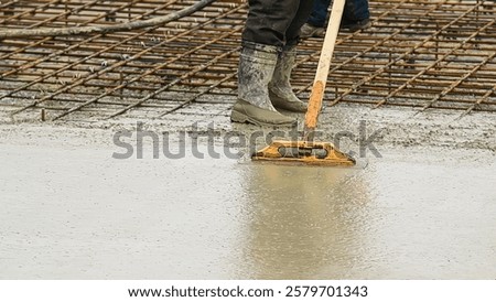 Workers are pouring structural concrete at a construction site. Concreting during construction