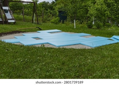 Workers prepare a swimming pool base using extruded polystyrene foam boards and sand in the backyard.