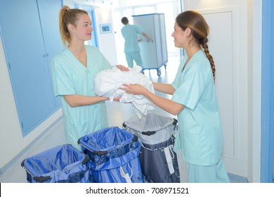 Workers Preparing Real Bags Of Hospital Laundry