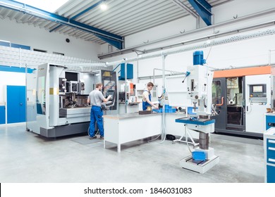 Workers Producing Industrial Appliances In Modern Factory, Wide Shot